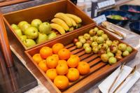 Zwei Obstkörbe mit Äpfeln, Orangen und Bananen auf einer Theke. in der Unterkunft Mercure Xiamen Science City in Xiamen