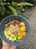 a person holding a blue bowl of food at Lanka Hotel in Mirissa