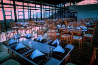 een eetkamer met tafels en stoelen met blauwe servetten bij Ramadia Grand Holiday Resort in Panadura