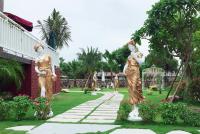 two statues of women standing in a garden at Sophia B&amp;B in Dongshan