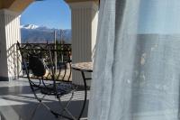 a table and a chair on a balcony with a view at Zodia Craiului in Peştera