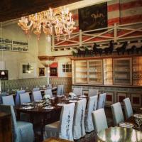 a dining room with tables and chairs and a chandelier at Villa Foscarini Cornaro in Gorgo al Monticano