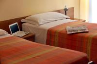 A bed or beds in a room at Albergo Centopini