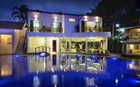 a house with a swimming pool at night at Angra Boutique Hotel in Angra dos Reis