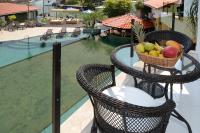 a basket of fruit sitting on a balcony next to a pool at Angra Boutique Hotel in Angra dos Reis