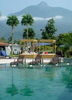 a swimming pool with two beds and chairs in the water at Angra Boutique Hotel in Angra dos Reis