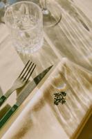 a table with a white table cloth with a fork and knife at Hôtel Saint-Georges in Megève