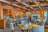 a restaurant with wooden walls and tables and chairs at River Crab Blue Water Inn in Marysville