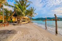 a house on a beach with palm trees and a wooden cross at Amore Villa by Utalay Koh Chang in Ban Khlong Son