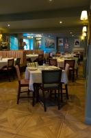 a dining room with tables and chairs in a restaurant at Pen y Bryn in Conwy
