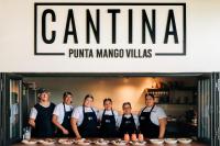 a group of people wearing aprons standing in a kitchen at Punta Mango Villas in La Periquera