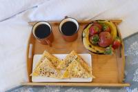 a tray with two cups of coffee and a plate of food at Sunrise Dreamworld Resort in Chonp