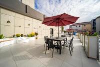 a patio with a table and chairs and an umbrella at Shanghai Rui deng hao Hotel-Free shuttle bus to Airport and Disneyland 24x7 in Shanghai