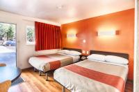 a hotel room with two beds and a table at Motel 6-Mammoth Lakes, CA in Mammoth Lakes