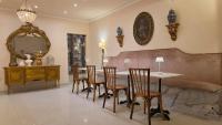 a dining room with a table and chairs and a couch at Hotel Casa La Tablada Aeropuerto in Cartagena de Indias