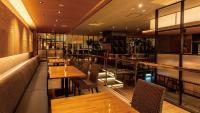 a restaurant with wooden tables and chairs and a bar at Koriyama View Hotel Annex in Koriyama