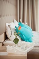 a vase with a flower on a tray on a bed at Hotel Versailles in Luts&#39;k