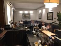 a group of people sitting at a bar in a restaurant at Pinewood Hotel Rome in Rome