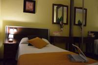 A bed or beds in a room at Hotel Complutense