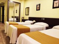 A bed or beds in a room at Hotel Complutense