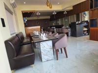 a dining room with a table and leather chairs at Hotel Diamond Crest, Patna in Lok Nayak Jayaprakash Airport