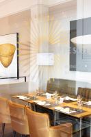 a dining room with a table and chairs at Hôtel de la Paix Lausanne in Lausanne