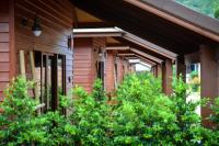 a building with green trees in front of it at PingChan Koh Phangan Beachfront Resort in Thong Nai Pan Yai