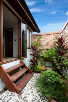 a house with a wooden door and some plants at PingChan Koh Phangan Beachfront Resort in Thong Nai Pan Yai