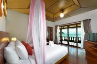 a bedroom with a bed and a view of the ocean at PingChan Koh Phangan Beachfront Resort in Thong Nai Pan Yai