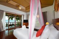 a bedroom with a bed and a window with a view at PingChan Koh Phangan Beachfront Resort in Thong Nai Pan Yai