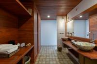 a bathroom with a large bowl sink and wooden walls at PingChan Koh Phangan Beachfront Resort in Thong Nai Pan Yai