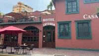 a hotel with tables and chairs in front of a building at Casa de Leyendas in Mazatlán