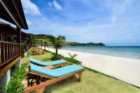 a beach with two lounge chairs and the ocean at PingChan Koh Phangan Beachfront Resort in Thong Nai Pan Yai