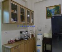 a kitchen with a counter with a microwave and a refrigerator at Amicasa Guesthouse in Hualien City