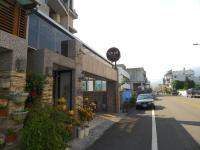 a car parked on a street next to a building at Amicasa Guesthouse in Hualien City