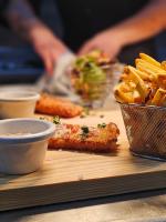 a table with french fries and a plate of food at Cottage Logis Hôtel - Restaurant in Dudelange