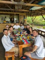 a group of people sitting at a table at Madre Selva Eco Lodge in Nuquí