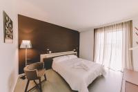 a hotel room with a bed and a chair at Suite 10 Home Design &amp; Spa in Polignano a Mare