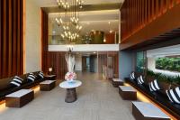 a lobby with couches and a table and a fishtank at Hisea Huahin Hotel in Hua Hin