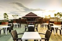 a patio with tables and chairs and a grill at Hisea Huahin Hotel in Hua Hin