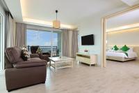 a hotel room with a bed and a living room at Hisea Huahin Hotel in Hua Hin