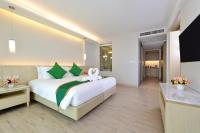 a hotel room with a bed with a bow on it at Hisea Huahin Hotel in Hua Hin
