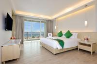 a bedroom with a large bed and a large window at Hisea Huahin Hotel in Hua Hin