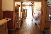a kitchen with a tiled floor and a hallway at Pension Post in Twiste