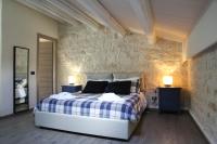 Łóżko lub łóżka w pokoju w obiekcie Villa Antica Aia Relax