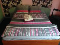 A bed or beds in a room at Hotel Bilyana