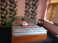 A bed or beds in a room at Hotel Bilyana
