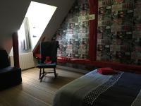 a bedroom with a bed and a wall with a spiderman mural at Fleur House in Teloché