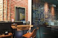 a bar with a chair and a brick wall at Atami Hotel in Taipei