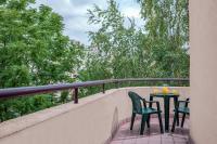 a table and chairs on a balcony with trees at Citadines Bastille Gare de Lyon Paris in Paris